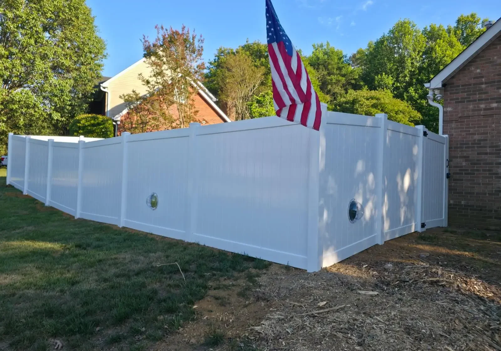 two pet windows on white fence